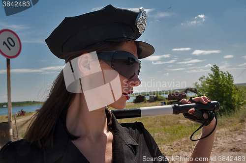 Image of Sexy woman in uniform holding stick