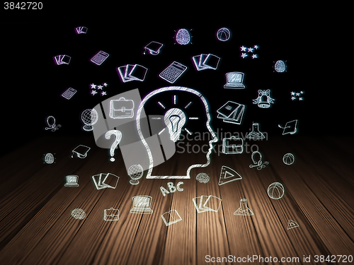 Image of Learning concept: Head With Lightbulb in grunge dark room