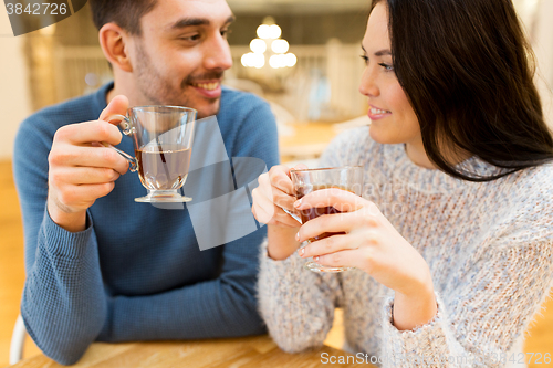 Image of happy couple drinking tea at cafe