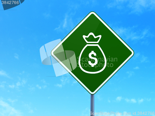 Image of Currency concept: Money Bag on road sign background