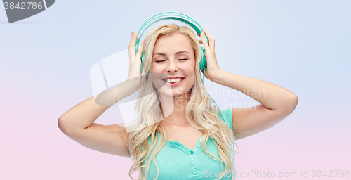 Image of happy young woman or teenage girl with headphones