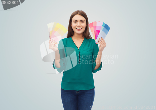 Image of smiling young woman with color swatches