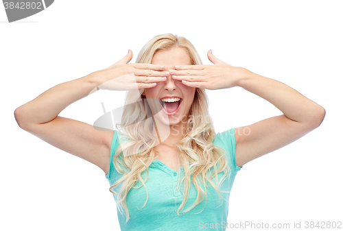 Image of smiling young woman or teen girl covering her eyes
