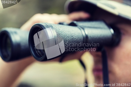 Image of close up of soldier or hunter with binocular