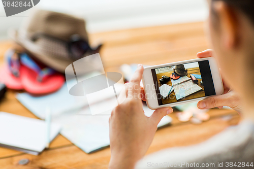 Image of close up of woman with smartphone and travel stuff