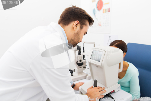 Image of optician with autorefractor and patient at clinic