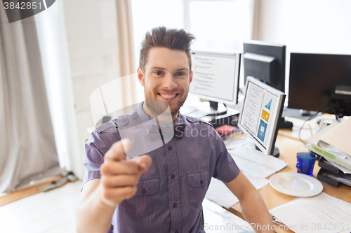 Image of happy male office worker pointing finger at you