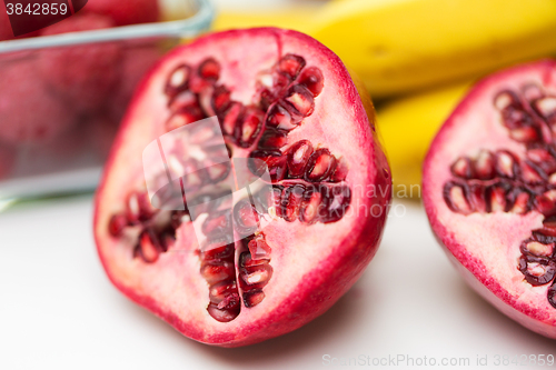 Image of close up of ripe pomegranate and other fruits