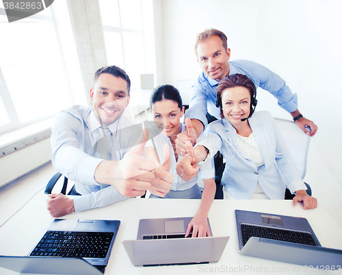 Image of group of office workers showing thumbs up