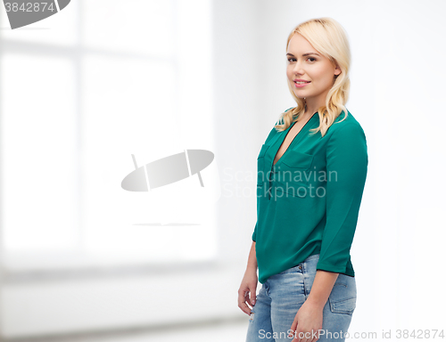 Image of smiling young woman in shirt and jeans