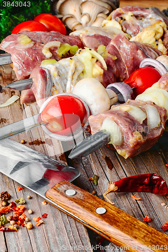 Image of raw meat on skewer