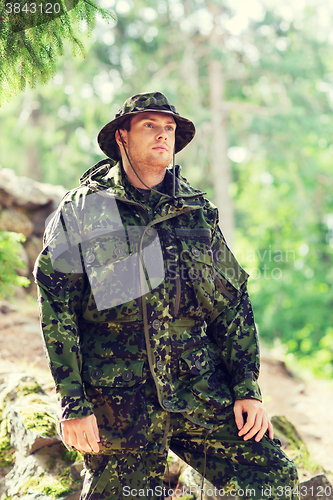 Image of young soldier or ranger in forest