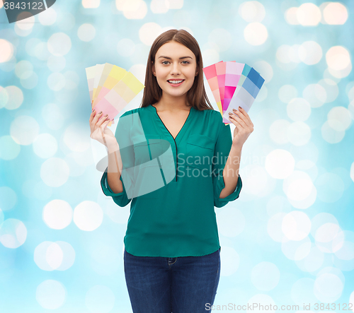 Image of smiling young woman with color swatches