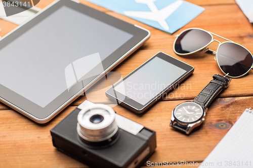 Image of close up of smartphone and travel stuff