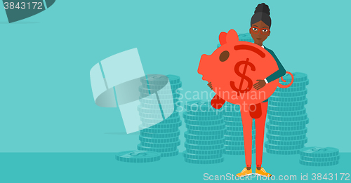 Image of Woman carrying piggy bank.