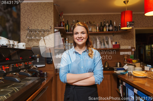 Image of happy barista woman at coffee shop