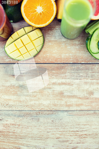 Image of close up of fresh juice glass and fruits on table