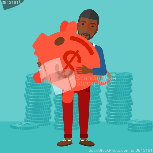 Image of Man carrying piggy bank.