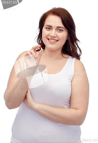 Image of happy plus size woman in underwear with pill