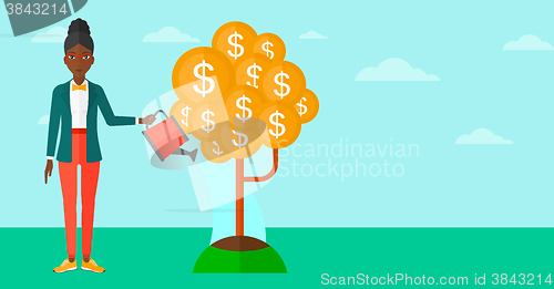 Image of Woman watering money tree.