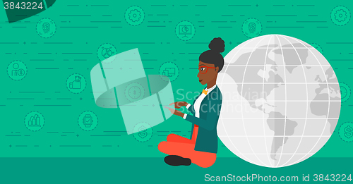 Image of Woman sitting near globe.