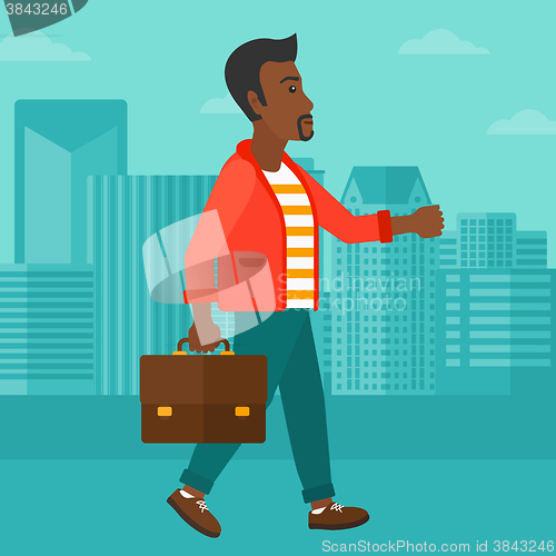 Image of Businessman walking with briefcase. 