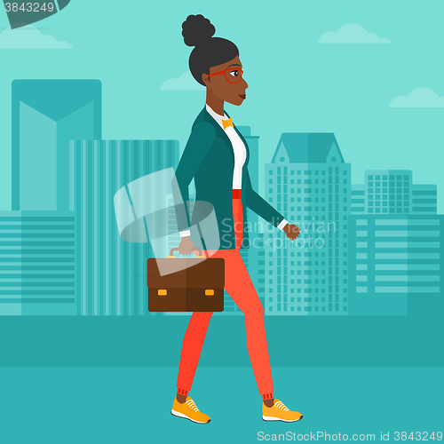 Image of Business woman walking with briefcase. 