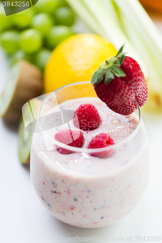 Image of close up of glass with milk shake and fruits