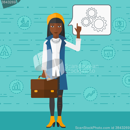 Image of Business woman pointing at cogwheels.