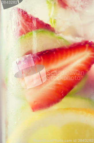 Image of close up of fruit water in glass bottle