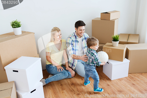 Image of happy family moving to new home and playing ball