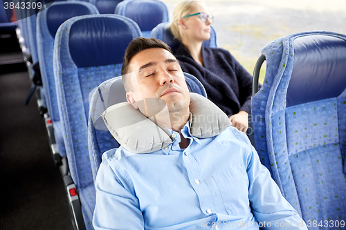 Image of man sleeping in travel bus with cervical pillow