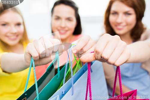 Image of close up of happy teenage girls with shopping bags