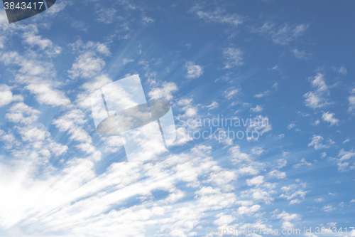 Image of Summer sky with small Altocumulus clouds and bright sunrays sunb