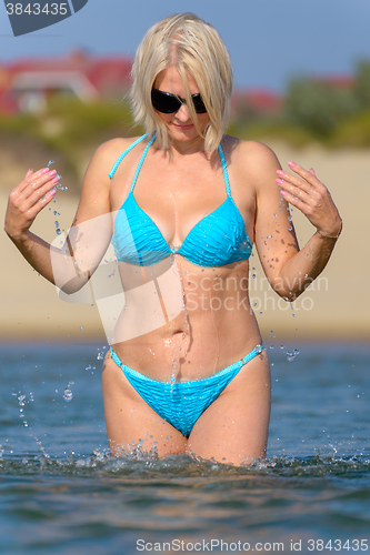 Image of Woman in a blue bikini