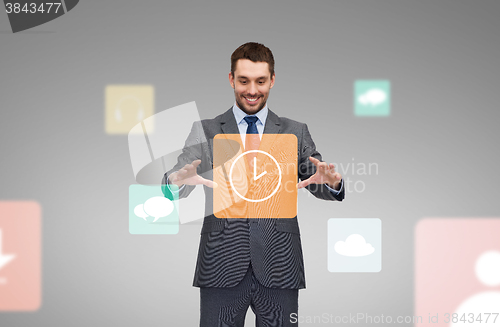 Image of businessman working with clock icon projection