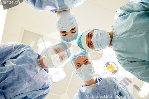 Image of group of surgeons in operating room at hospital