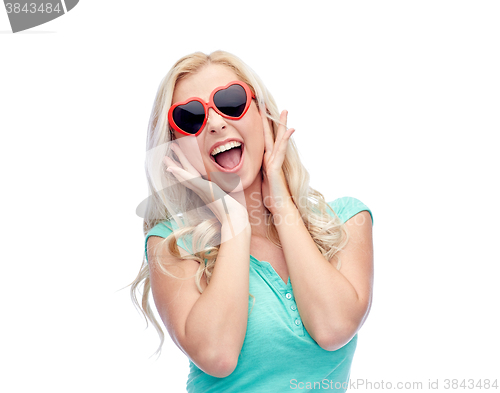 Image of happy young woman in heart shape sunglasses