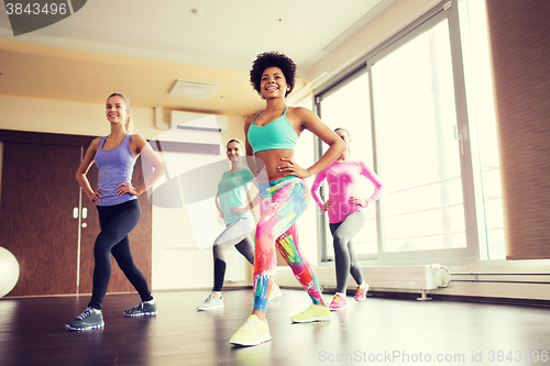 Image of group of happy women working out in gym