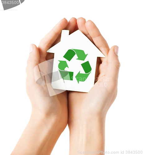 Image of hands holding house with green recycling sign