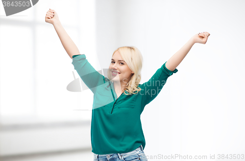 Image of smiling young woman in shirt and jeans