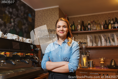 Image of happy barista woman at coffee shop