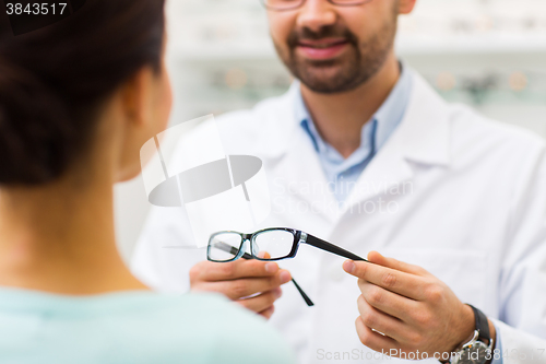 Image of close up of optician with glasses at optics store