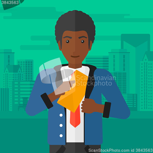 Image of Man putting envelope in pocket.