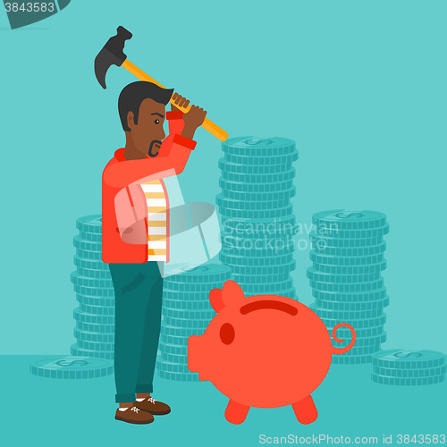 Image of Man breaking piggy bank.