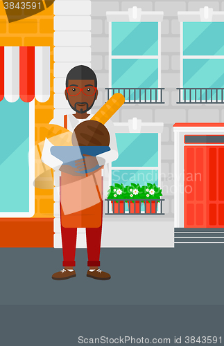 Image of Bakery owner with bread.