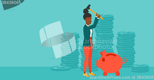 Image of Woman breaking piggy bank.