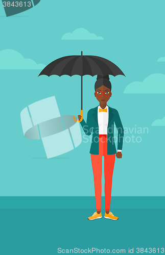 Image of Business woman standing with umbrella.