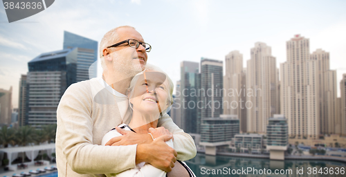 Image of senior couple hugging over dubai city waterfront