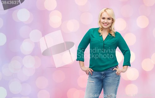 Image of smiling young woman in shirt and jeans